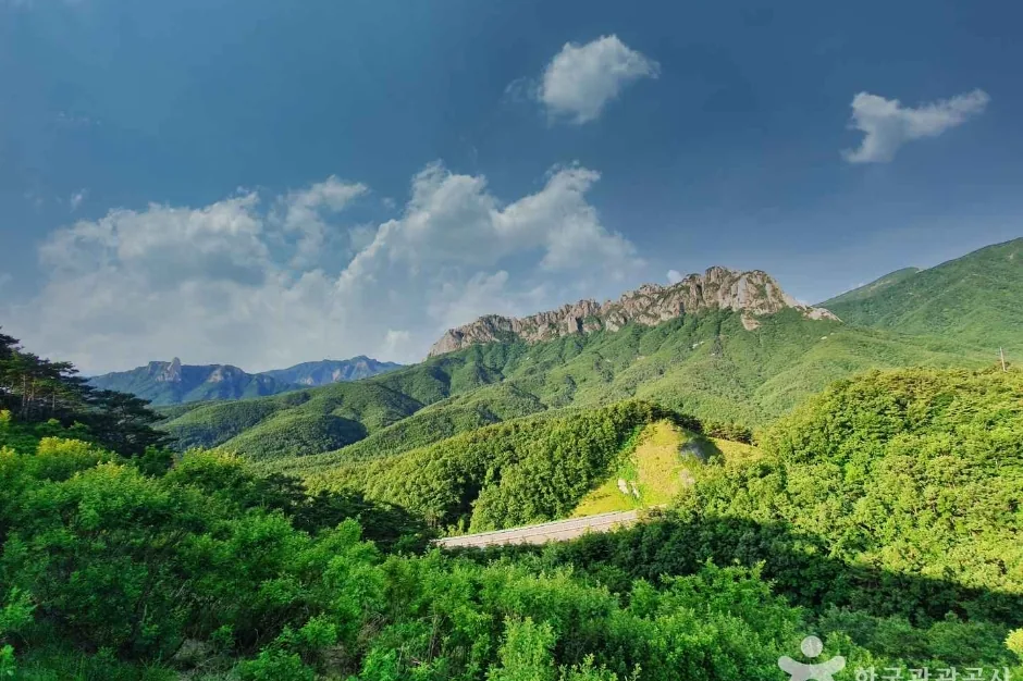 The granite mass of Ulsanbawi Rock above summer forest, Seoraksan